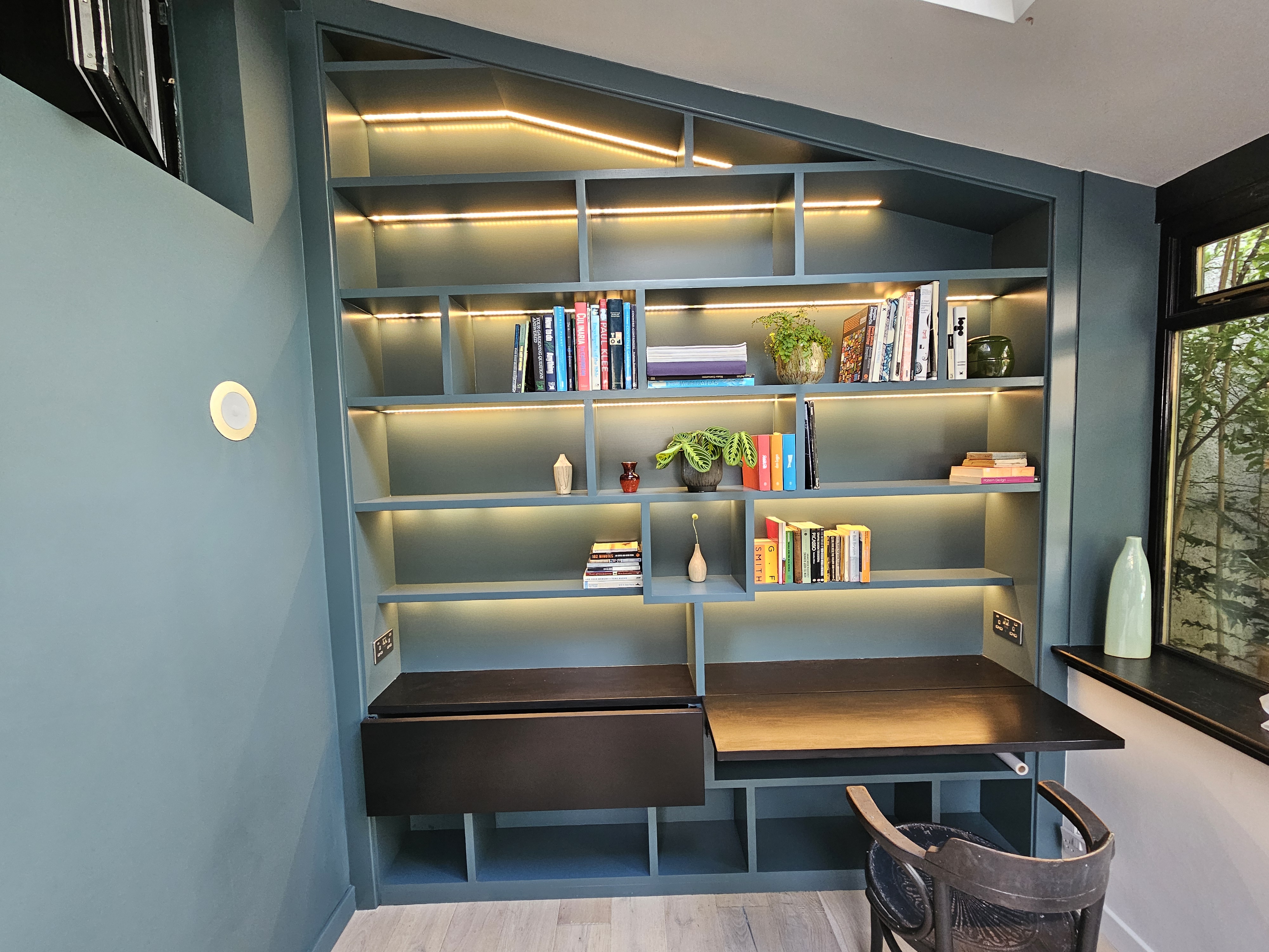 Bookcase with integrated desk and LED lighting