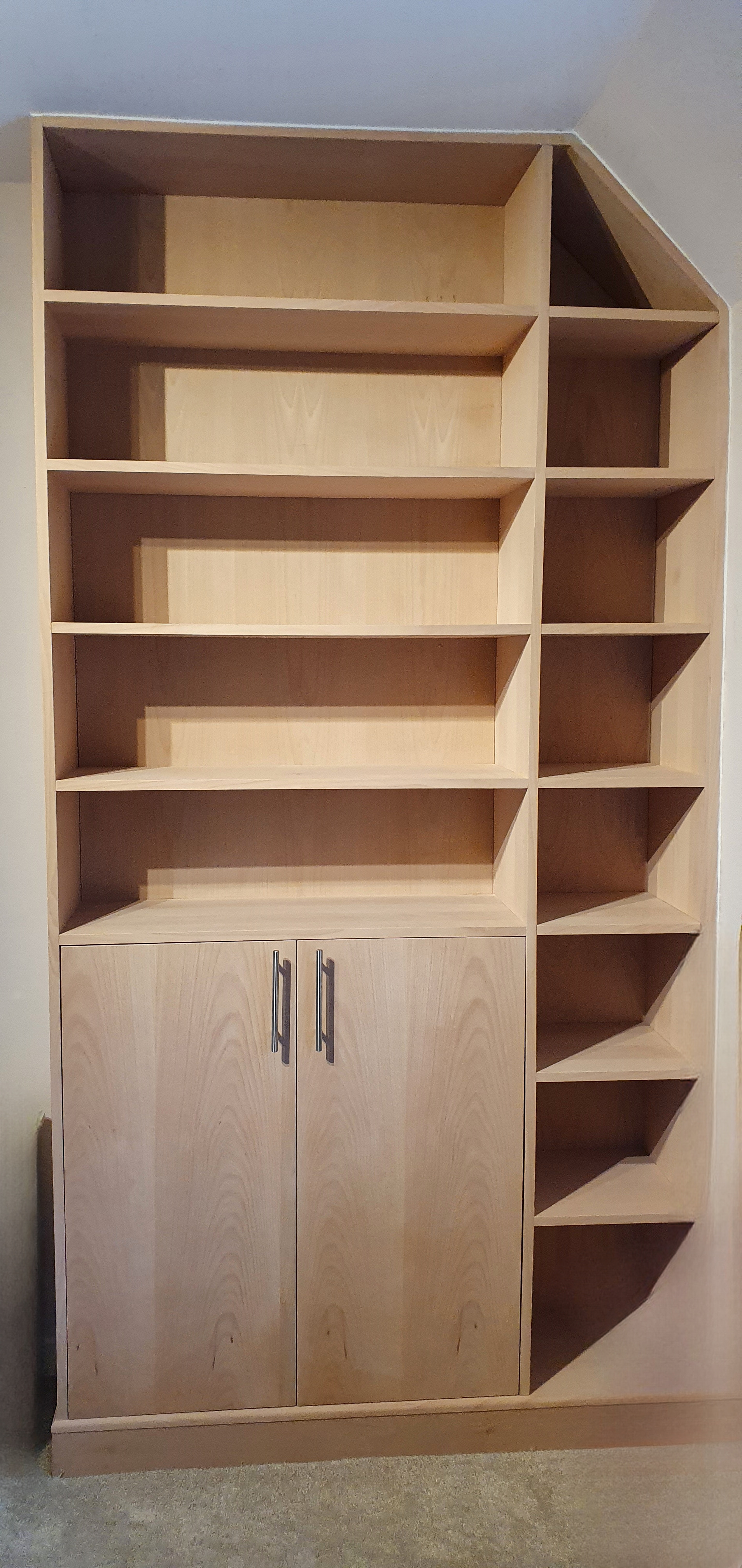 Geometric corner bookcase with custom shelving